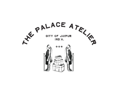 A black logo graphic on a white background featuring the text 'THE PALACE ATELIER' arched over 'CITY OF JAIPUR INDIA.' and a simple line drawing of two figures standing beside stacked boxes.
