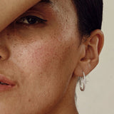 Model wearing a Diya Star Hoop Earring