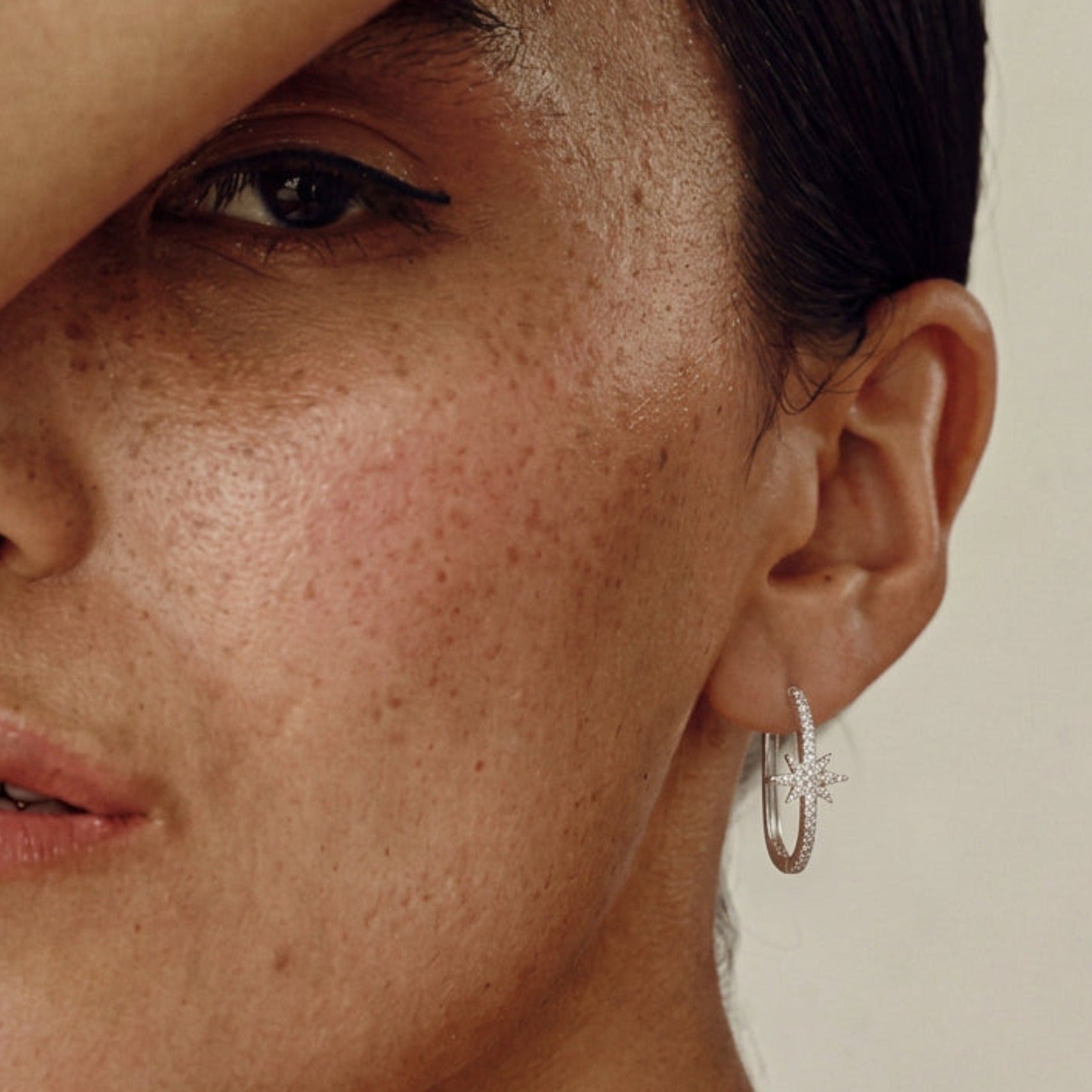 Model wearing a Diya Star Hoop Earring